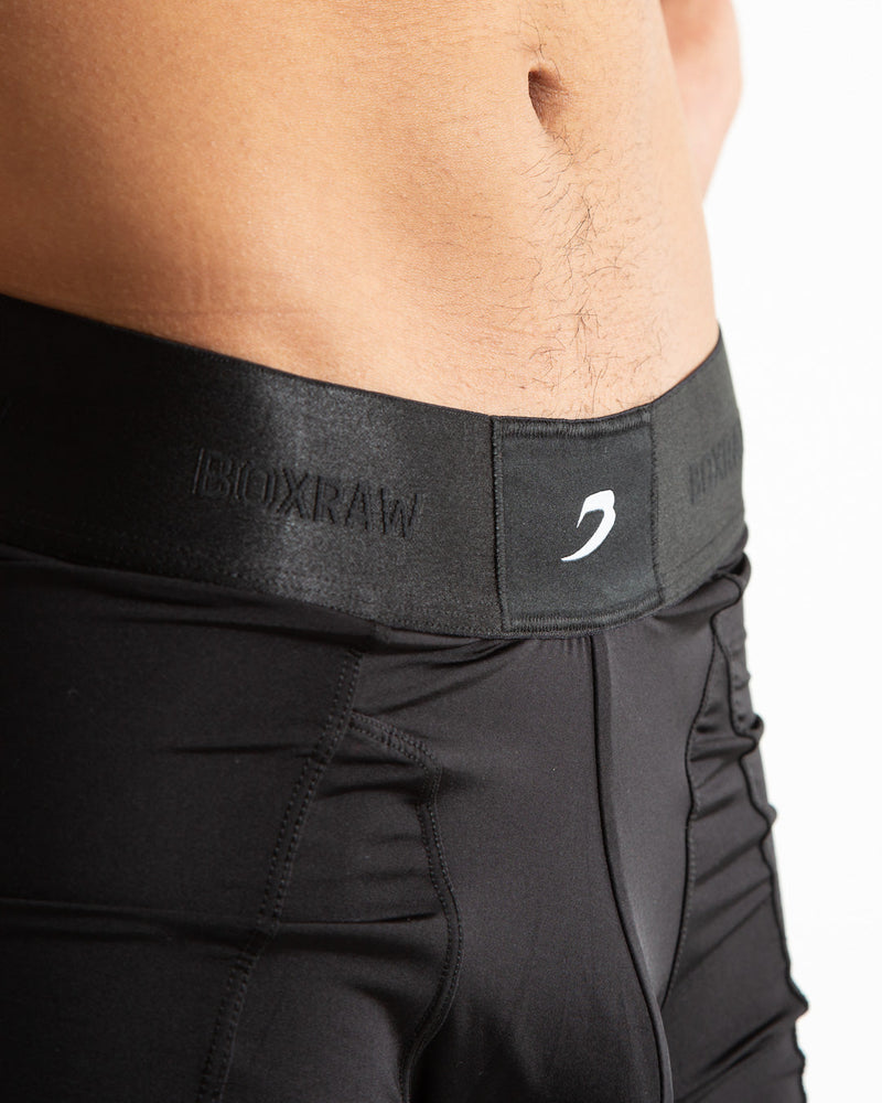 Man in black nylon slim fit boxers with white strike logo on waistband