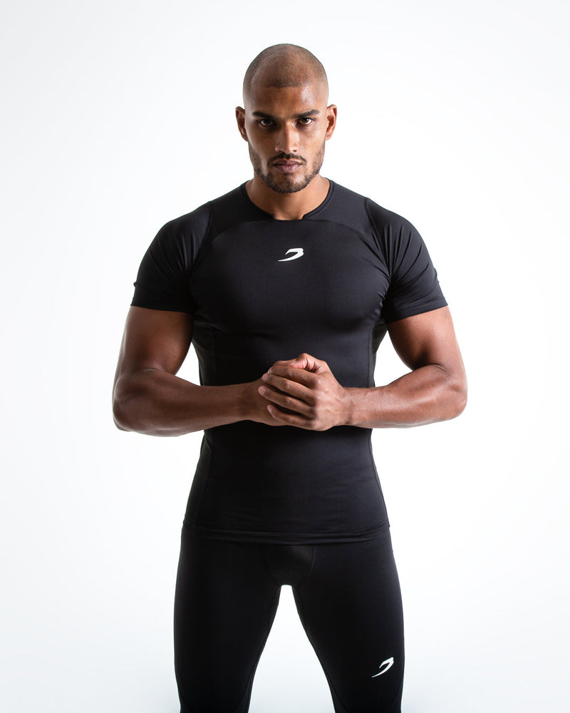 Man in black compression long sleeved t-shirt made from mesh fabric and targeted ventilation panels with white boxraw strike logo on the chest.