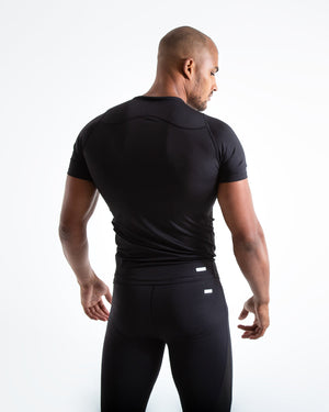 Man in black compression long sleeved t-shirt made from mesh fabric and targeted ventilation panels with white boxraw strike logo on the chest.