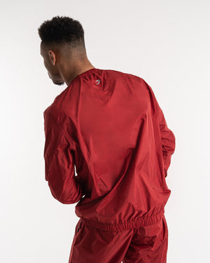 Man in a red sauna suit tracksuit with a white boxraw logo on the chest as well as adjustable wrist straps and made from polyester.
