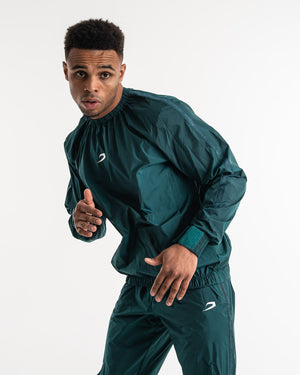 Man in a green sauna suit tracksuit with a white boxraw logo on the chest as well as adjustable wrist straps and made from polyester.