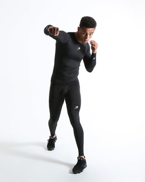 Man in black compression long sleeved t-shirt made from mesh fabric and targeted ventilation panels with white boxraw strike logo on the chest